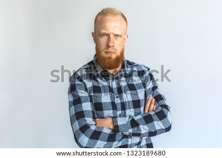 Red hair mature man standing isolated on grey wall crossed arms looking camera confused close-up