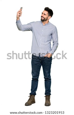 Full-length shot of Elegant man with shirt making a selfie on isolated white background