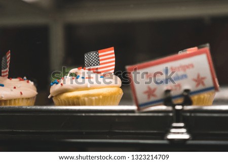 This is photo taken in a bakery. Memorial's day was around the corner and this cake and sign has the flag and the american flag colors