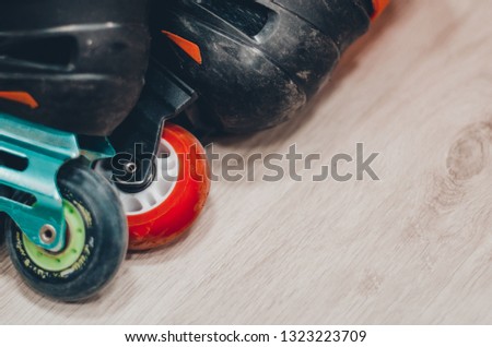 Black roller skates on the roller rink. Wheels close up view. Ready to skate concept.