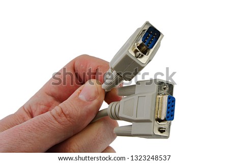 Historical RS-232 communication cables, male and female, held in left hand of adult person, white background	 Royalty-Free Stock Photo #1323248537