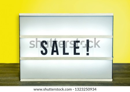 Light box with Sale letters against yellow background