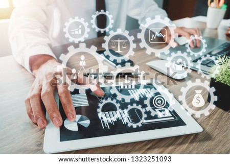 Businessman hand working with digital tablet and modern computer with VR icon diagram at office.Digital marketing media in virtual screen.