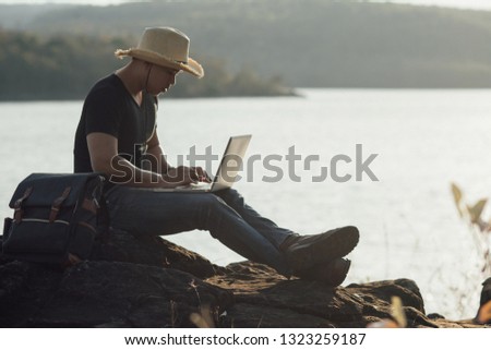 Backpacker relax on the Mountain with using laptop