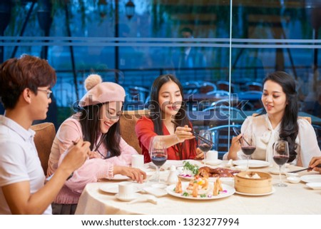 Group of Vietnamese young people eating out on Saturday night