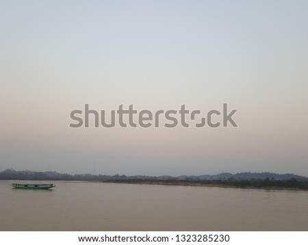 River view background with small boat The backdrop is mountain and sky. After sunset