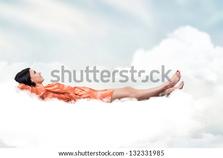 Beautiful girl, sleeping on a white cloud Royalty-Free Stock Photo #132331985