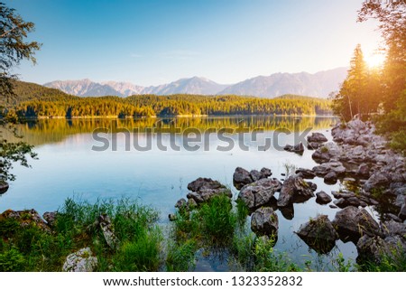 Azure water at Eibsee lake at the foot of Mt. Zugspitze. Location famous resort Garmisch-Partenkirchen, Bavarian alp, Europe. Scenic image of popular travel destination. Discover the world's beauty.