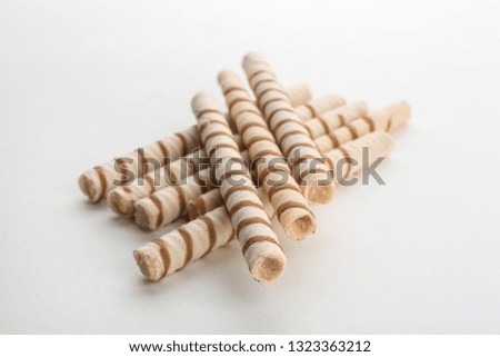 Delicious wafer rolls on white background. Sweet food