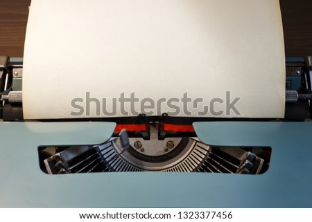 Vintage typewriter with blank paper. Space for text. The concept on literature, historical, education.