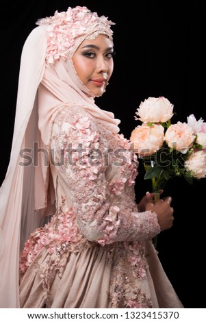 Asian Charming muslim arabic bride in Lace Bead Embroidery Sweet Pink old rose wedding dress and hijab headscarf, close-up on Fashion Make up Eyes Face, studio lighting black background isolated.