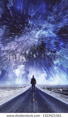 Back view of man on creative road with cloudy night sky background. Freedom and opportunity concept 