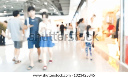 Blurred pictures of couples walking in the mall.