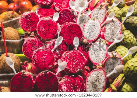 Dragon fruit or Pitaya white and red rose open in market ready to eat. Fashion fruit to eat market spoon