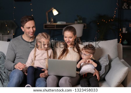 Happy family watching cartoons at home