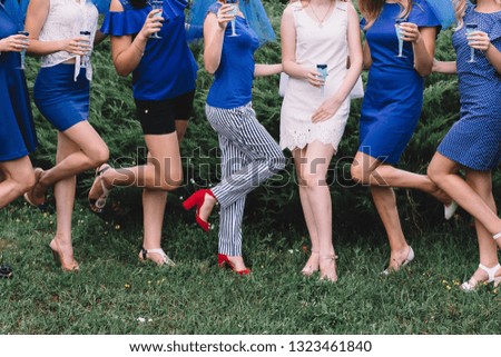 Bachelorette party, girls in blue dresses with glasses of champagne are having fun.