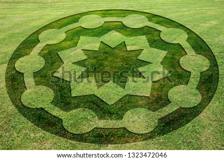 Concentric circles and stars symbols fake crop circle in the meadow         