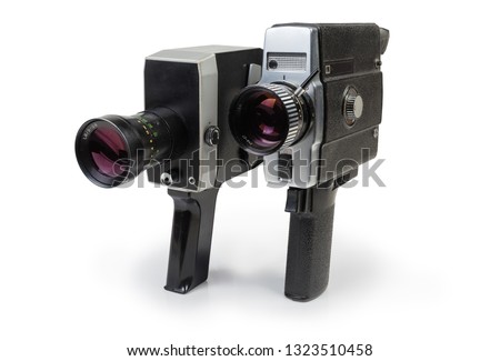 Two old vintage amateur film movie cameras Super 8 mm format powered by clockwork motor and electric motor on a white background 
