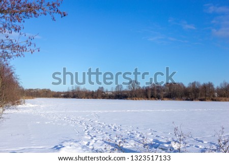 snow lake on a clear sunny day and blue sky