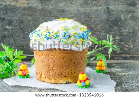 Easter kulich. Paska. Easter cakes with raisins and icing on wooden background