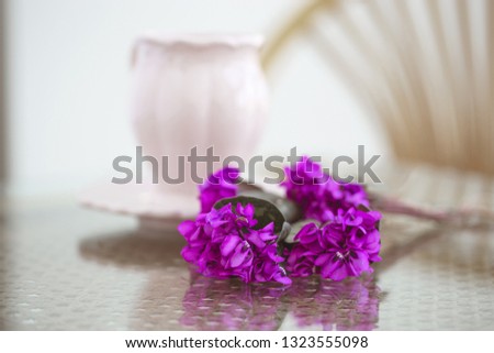 Violets on a lace napkin with a cup of coffee. Romantic spring breakfast