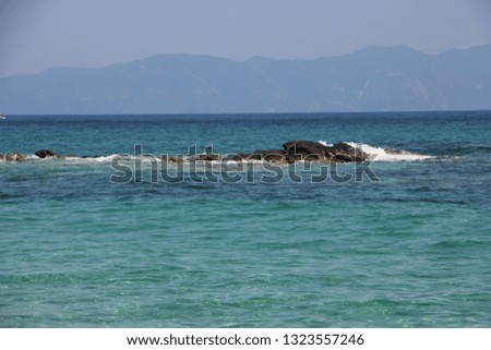 View of turquoise sea and the rocks near of touristic place Sarti on Sithonia peninsula of Chalkidiki, Greece. Nature background.