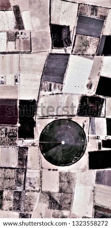 The power of the wind, farms of human crops in desert, tribute to Pollock, vertical  abstract photography of the deserts of Africa from the air, aerial view, abstract expressionism,abstract naturalism