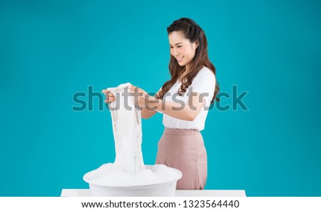 Asian woman washing clothes by hand
