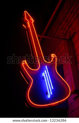 red neon guitar with blue strings