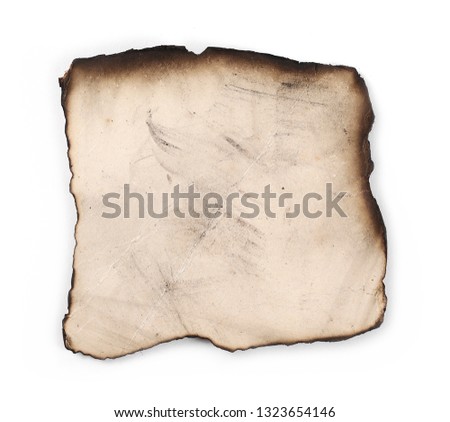 Burned and charred paper scrap isolated on white background, top view
