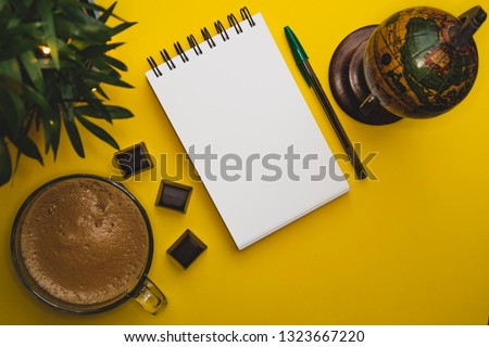 Coffee mug globe photo yellow background green notebook keyboard instant camera cards free space plants chocolate 