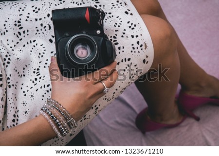 Girl hold camera.