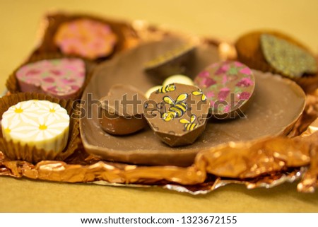 A close up of a group of handmade chocolates over a craft paper background