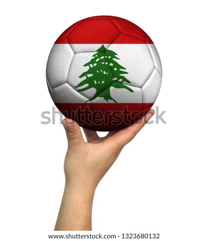 Man holding Soccer ball with Lebanon flag, isolated on white background.