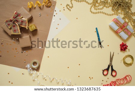 Top view of gift preparation. Items laying on yellow background. Flat lay