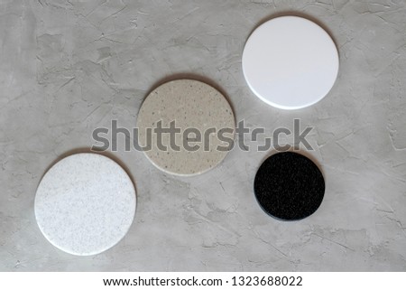 Round coasters made of artificial stone tabletop. Royalty-Free Stock Photo #1323688022