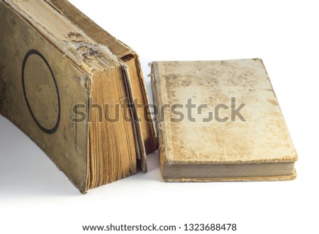
Dusty old books with broken covers on a white background