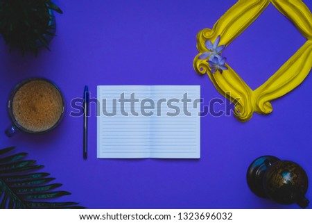 Purple background yellow frame notebook pen coffee mug globe flower flat lay instant photography camera keyboard computer 