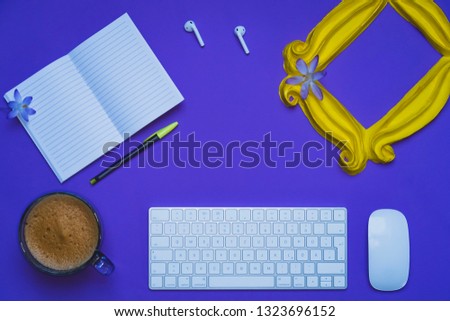Purple background yellow frame notebook pen coffee mug globe flower flat lay instant photography camera keyboard computer 