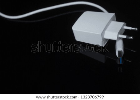 White usb charger on black background