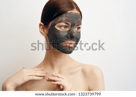 young woman in a clay care mask
