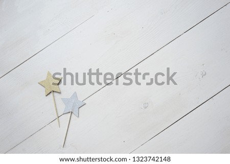 White wooden background for your text and design, top view, flat lay, with silver and golden star. Space for your signature, copy past - romantic and dreamer mood.