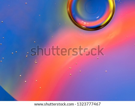 Water bubble glittering with multicolour lights. Close up macro shot. Blurred background. Motion of bubbles in liquid. Multicolour liquid universe, abstract background. Pattern of abstract space