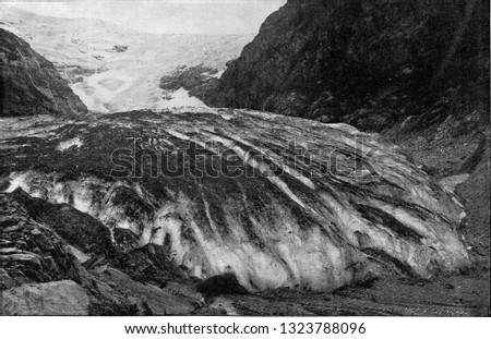 The Kjenndalsbreen at Lenodal in Norway, with a trail of scree and crevasses, in the foreground the glacier gate, vintage photo. From the Universe and Humanity, 1910.
