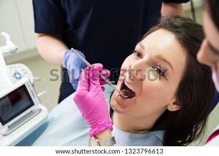 Dentist repairing patient teeth at the dental office