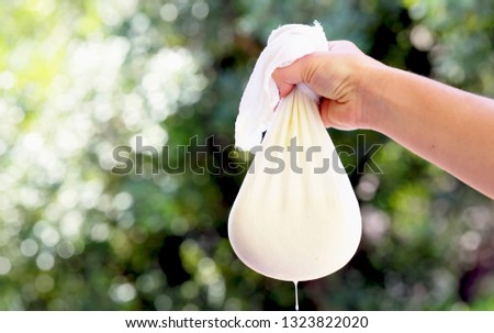 flowing cottage cheese in cheesecloth. Royalty-Free Stock Photo #1323822020