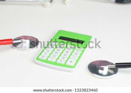 Stethoscope and calculator. Selectively focused.