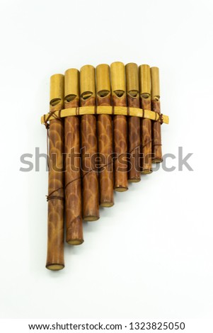 Pan flute instrument on white background.