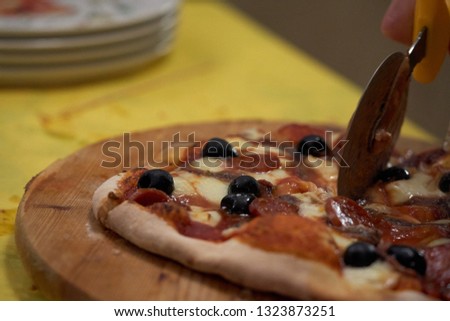 Cutting pizza on a cutting board