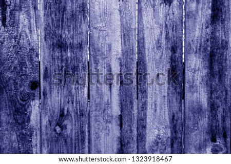 Old grunge wooden fence pattern in blue tone. Abstract background and texture for design.